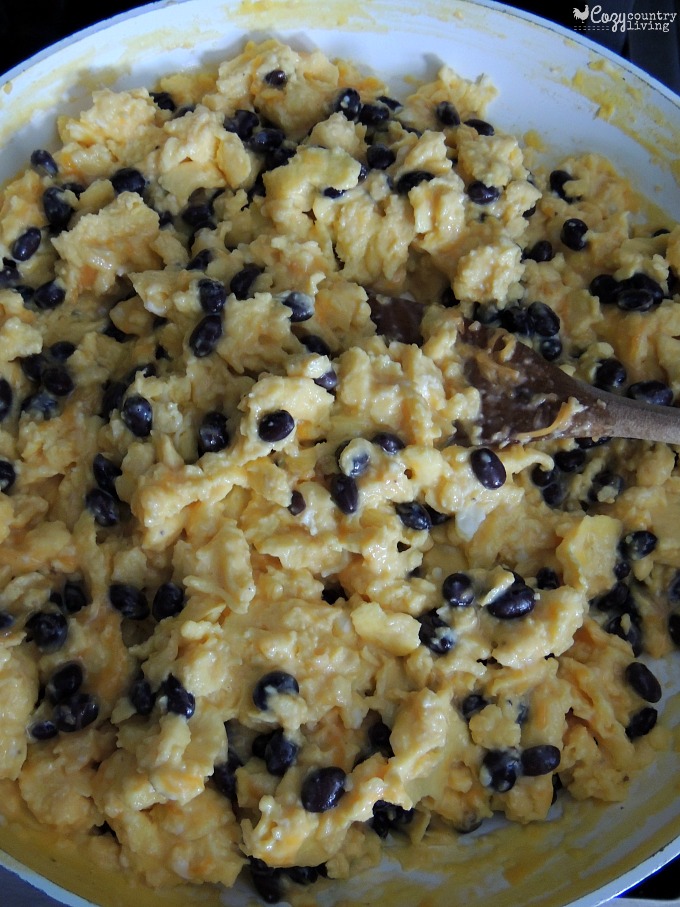 Scrambling Eggs with Cheese Black Beans for Burritos