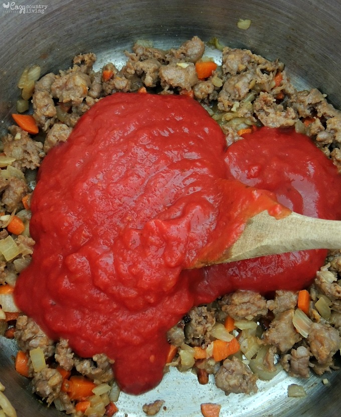 Adding Tomatoes to Sausage for Soup