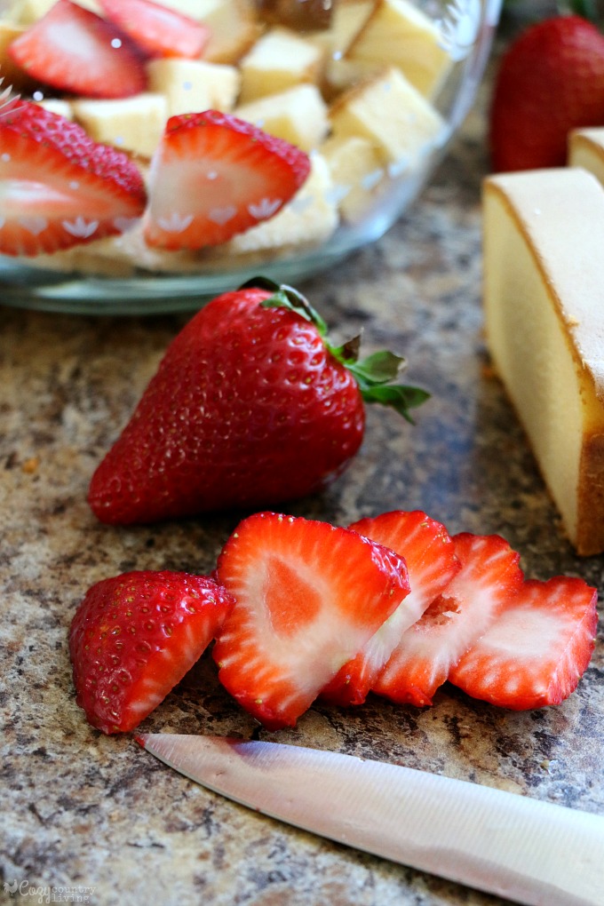 Adding Fresh Strawberries to the Trifle Dessert