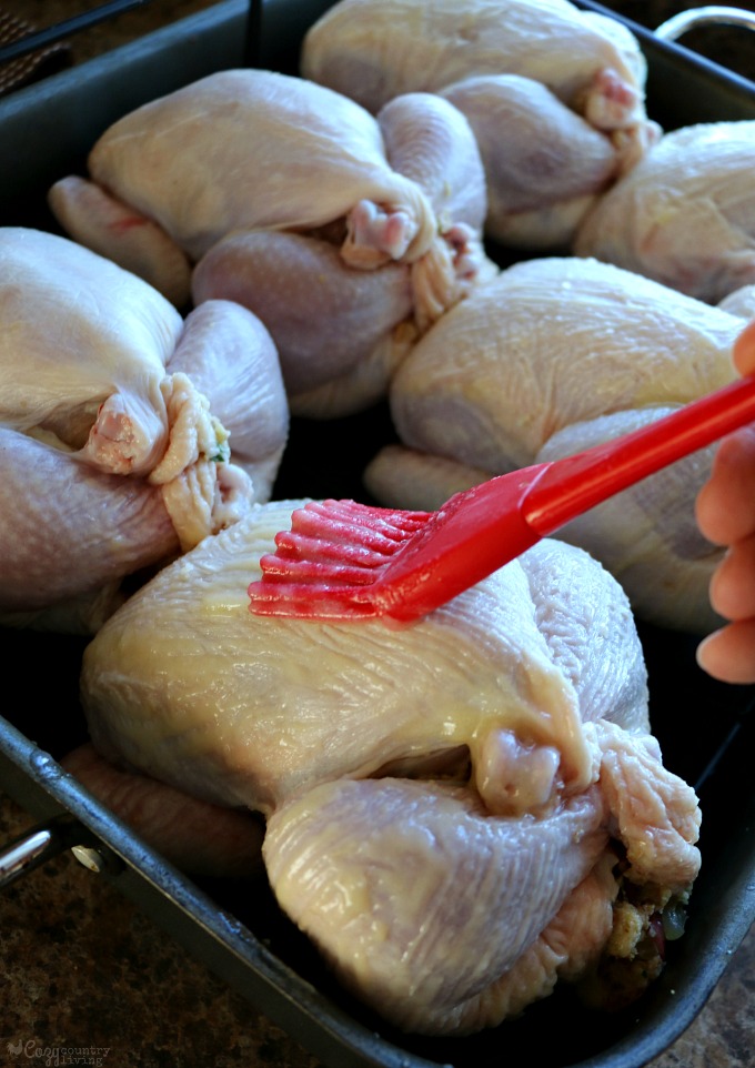 Brushing Cornish Hens with Butter before Roasting